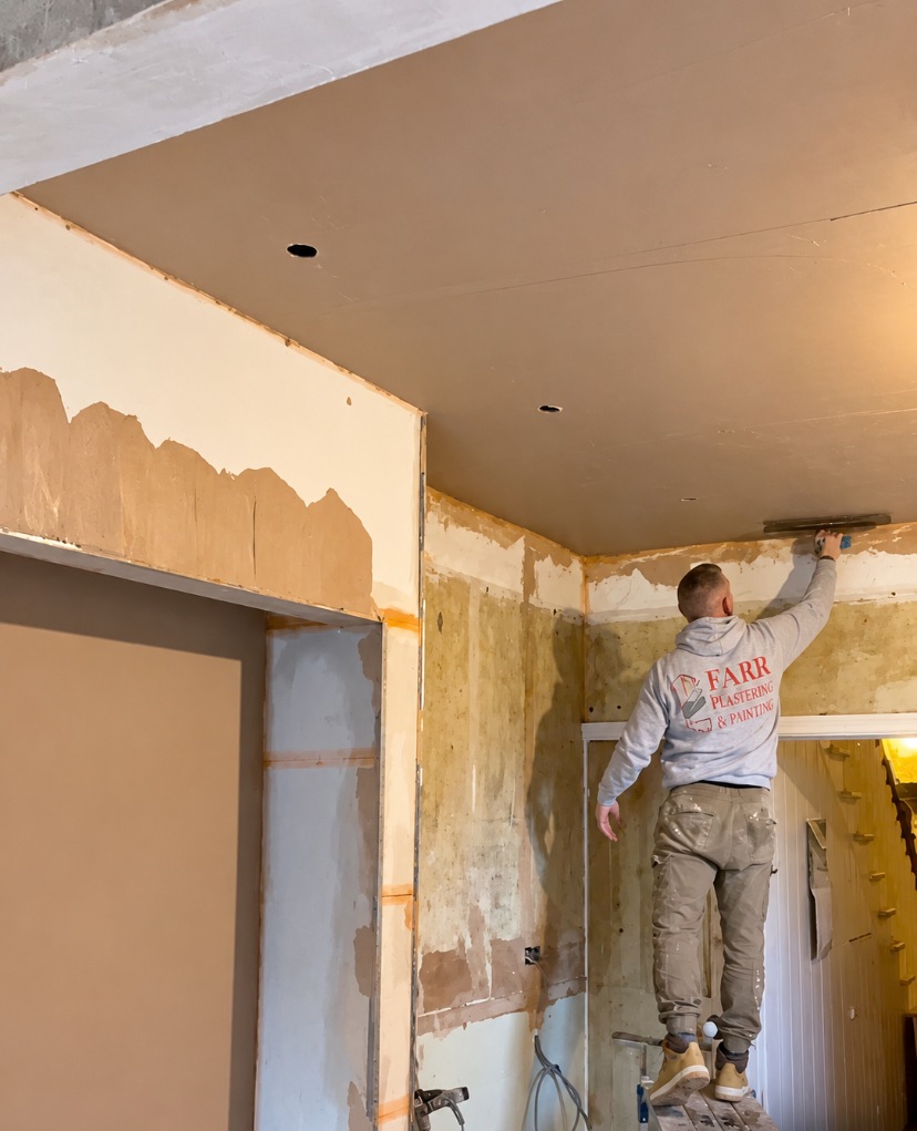 Ceiling plastering in progress on a hop-up platform in SE19.