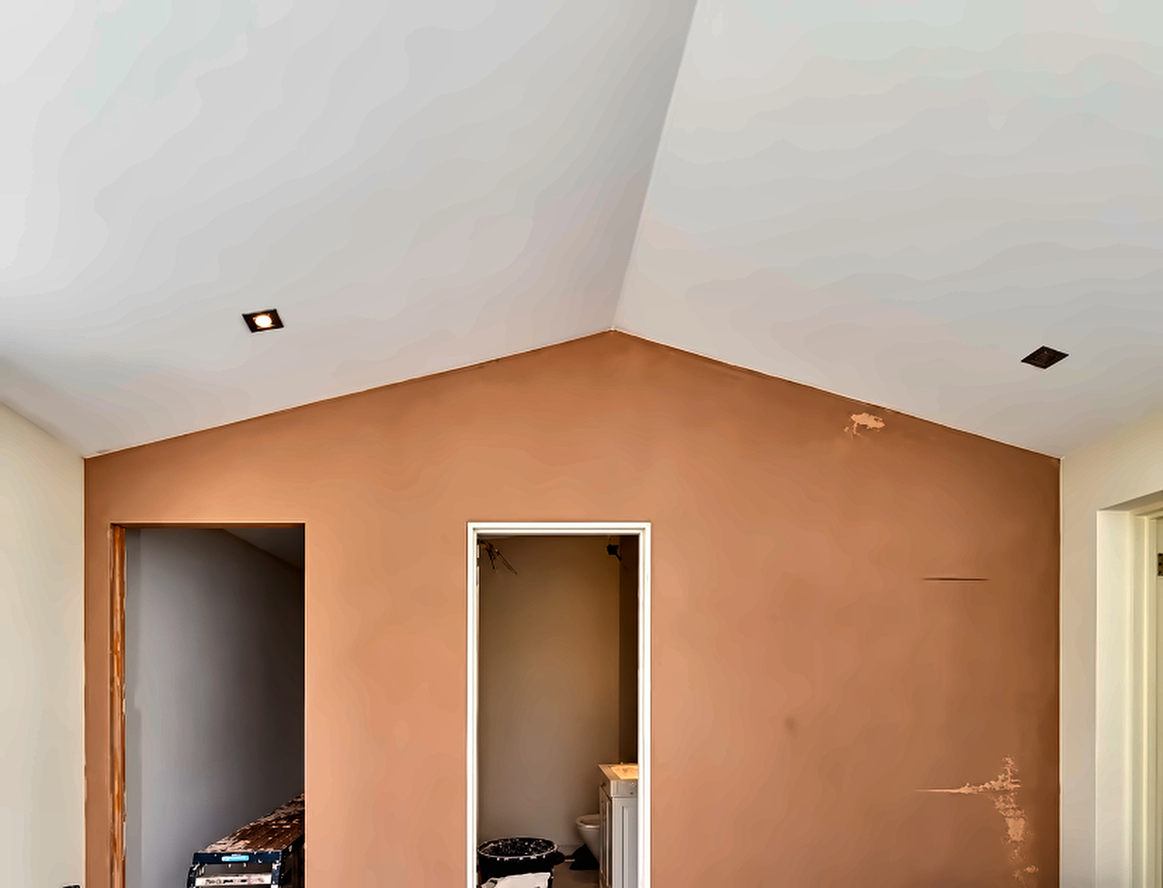 Gabled plaster wall and adjoining doorways in a SE London renovation.